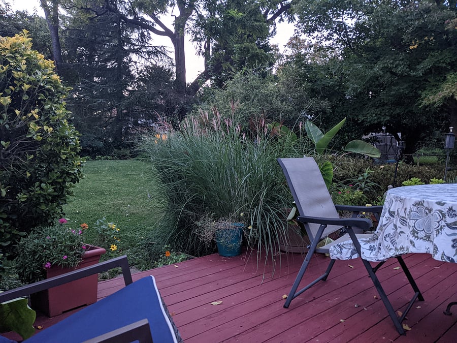Back deck - dining table in partial view. 2 rocking chairs.
