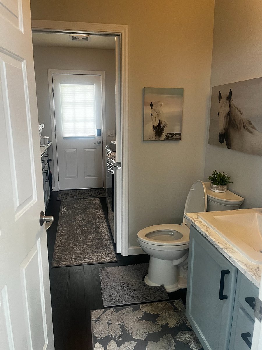 Closest half bathroom with toilet, sink and utility sink for washing dishes.