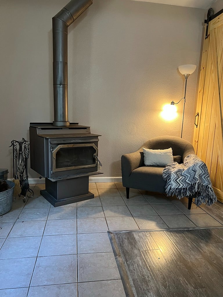 Wood stove and sitting area adjacent to kitchenette