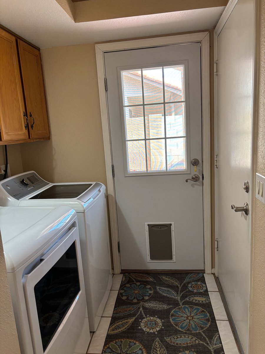Laundry area with door to garage and backyard. Dog door available for small dog.