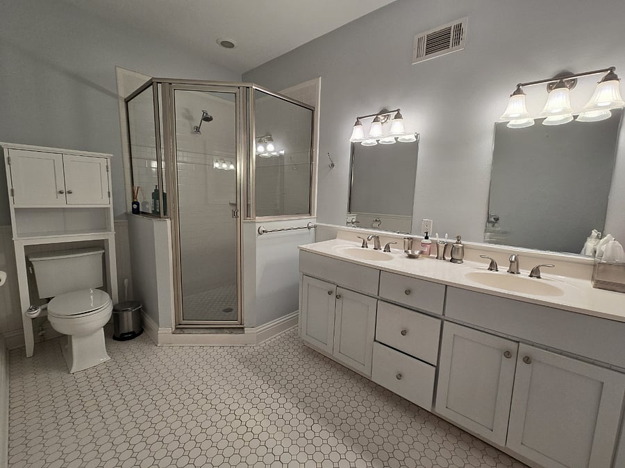 spacious primary bath with double vanity and large shower