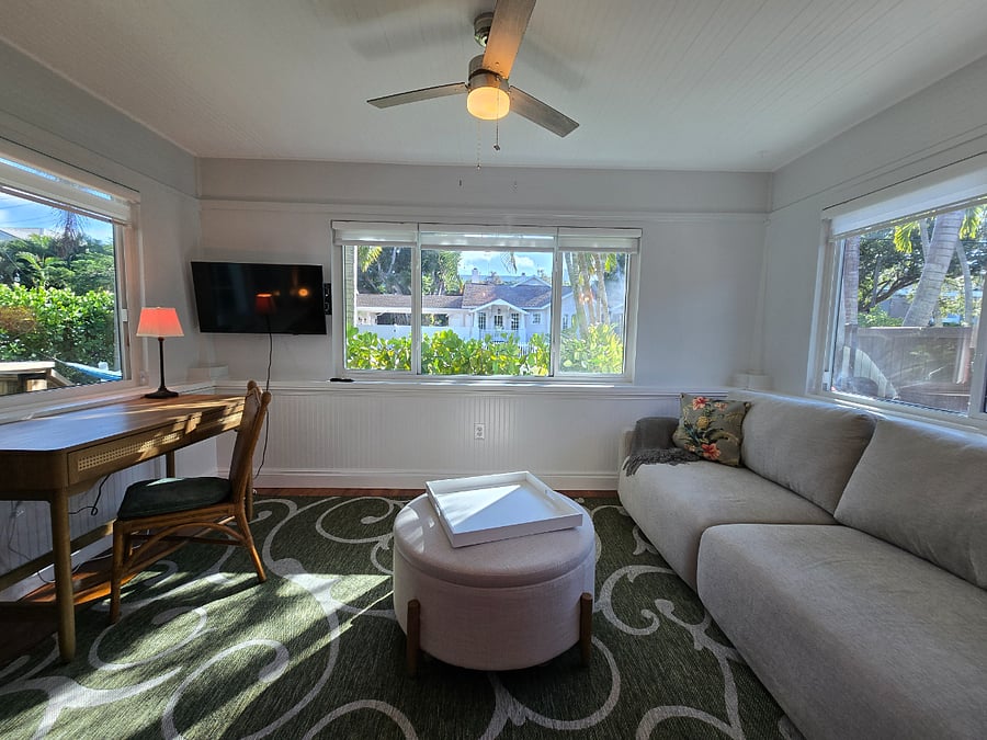 sunroom with TV, queen pull-out sofa for guests that seats 4 & dedicated work-from-home desk; 