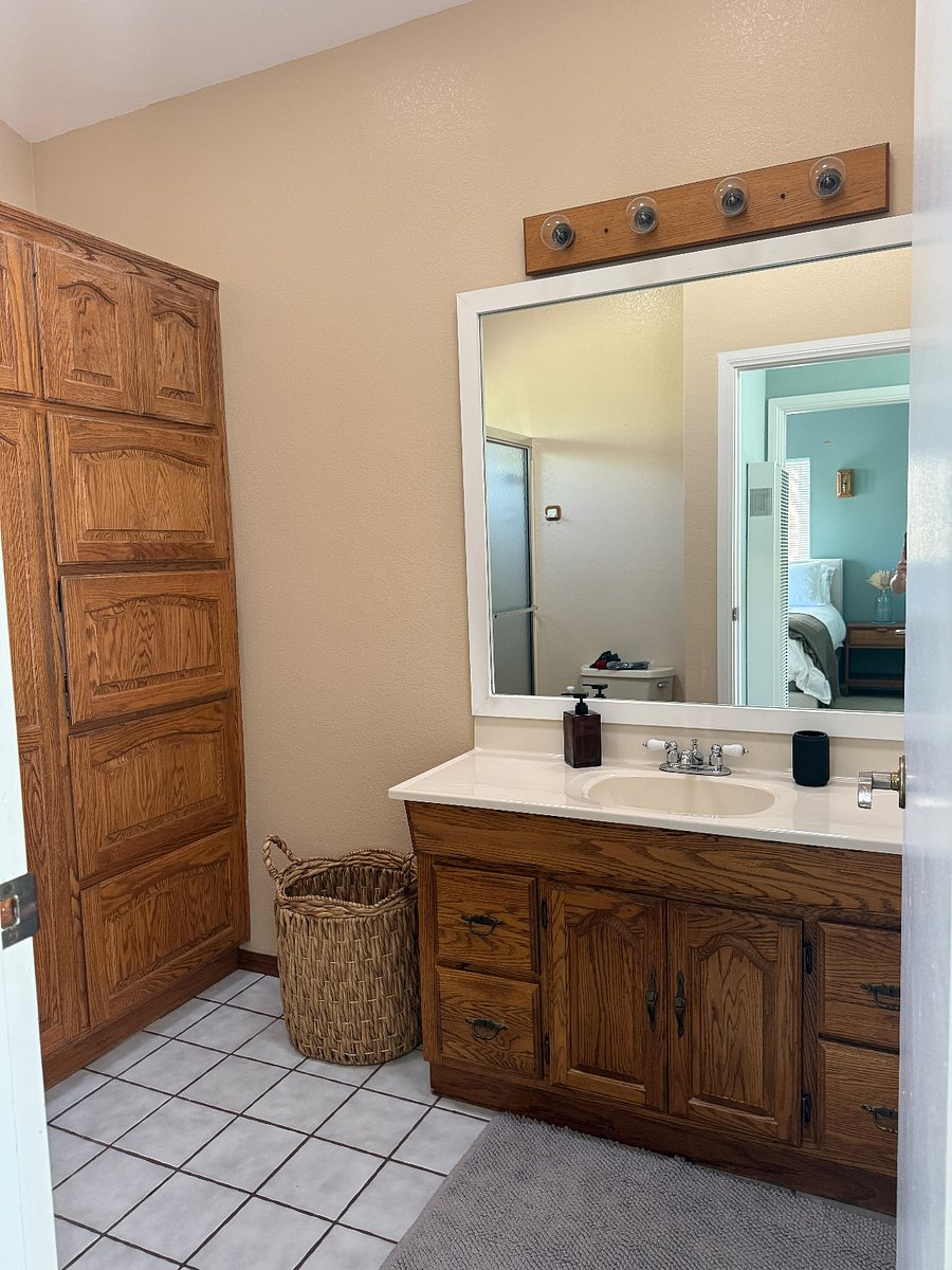 ample storage space in bathroom for towels and toiletries. 
