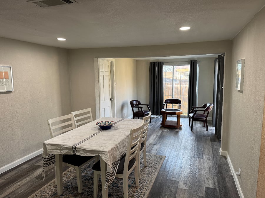 Dining table with seating for 4 adults along with a coffee area 