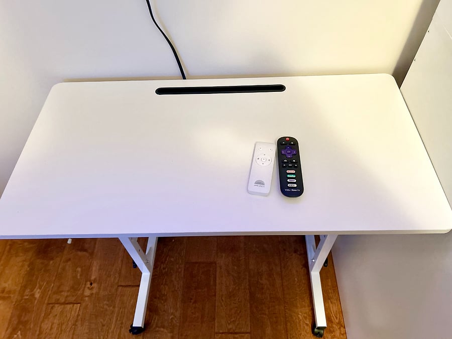 Rolling desk and remotes for motorized blind and TV