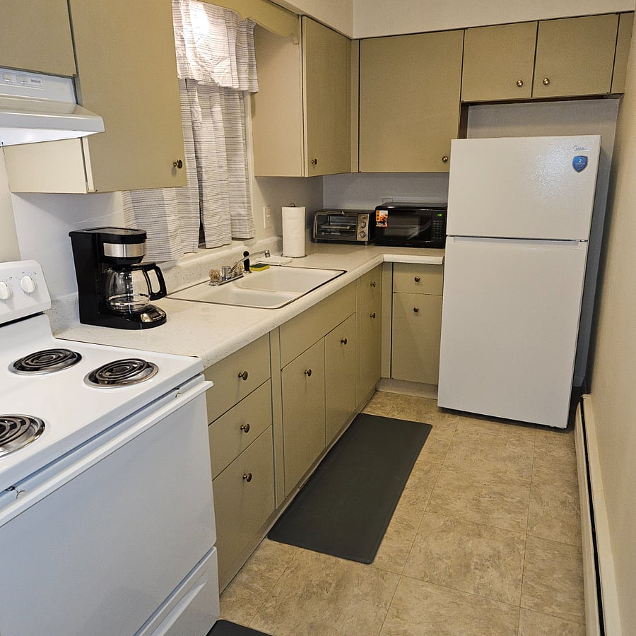 Large galley kitchen with plenty of cupboard space. Full size stove, new refrigerator, microwave, coffee maker, electric skillet, and toaster oven.