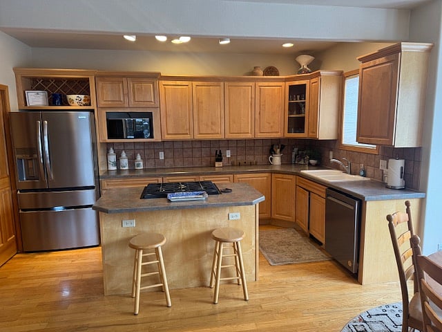 Spacious kitchen with breakfast bar and adjoining dining area.