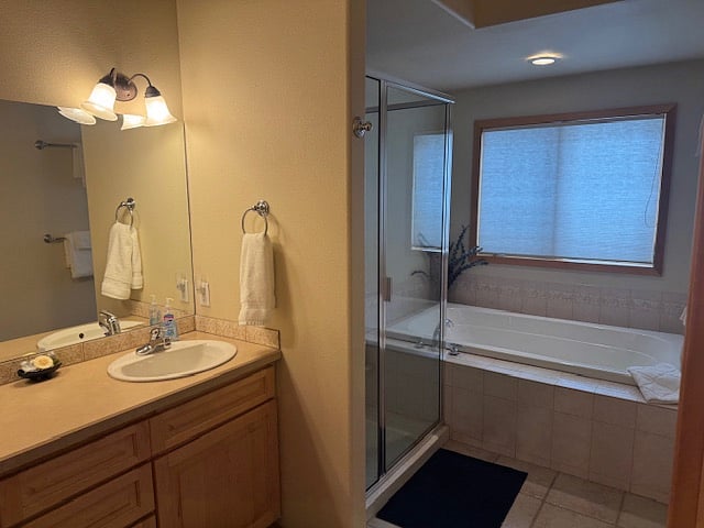 Primary bathroom with soaking tub, shower, double vanity and private toilet