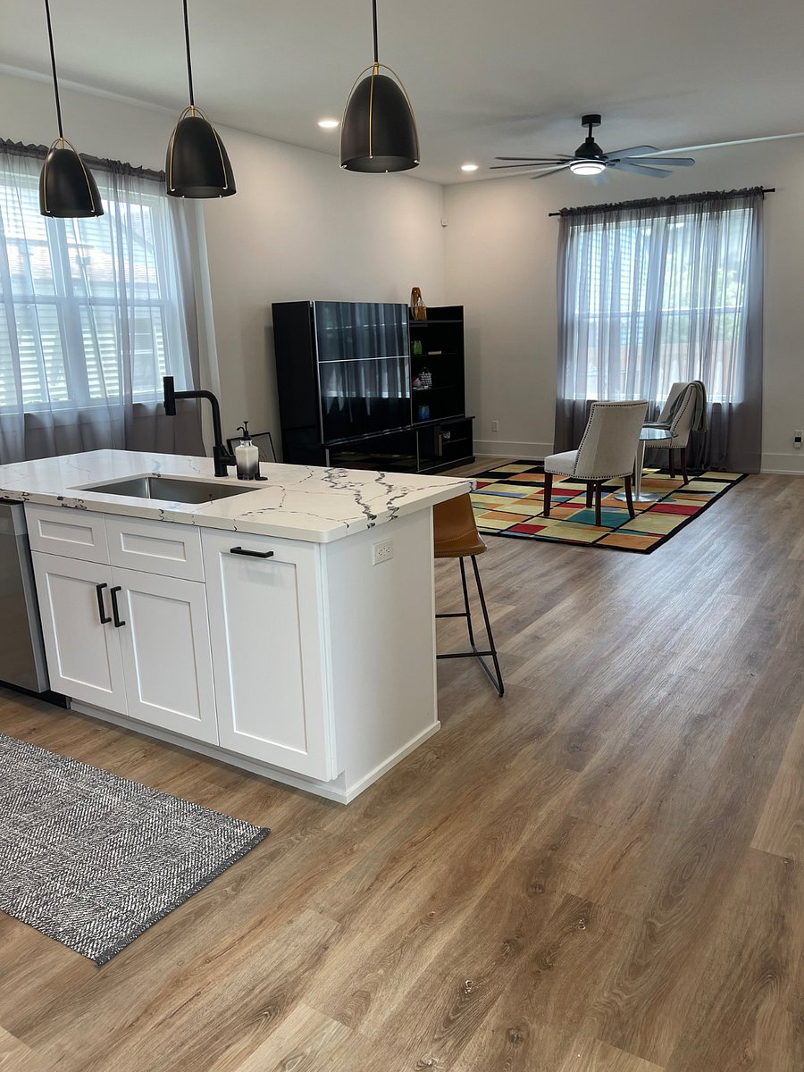 Open floor plan that involve a half bath, full kitchen and living area.