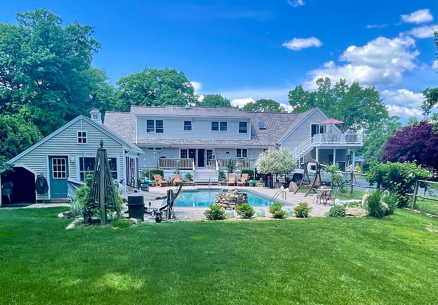 view of backyard and pool in the summer