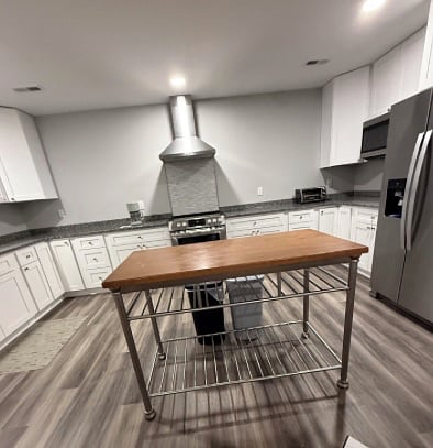 Kitchen. A food preparation table is centered.