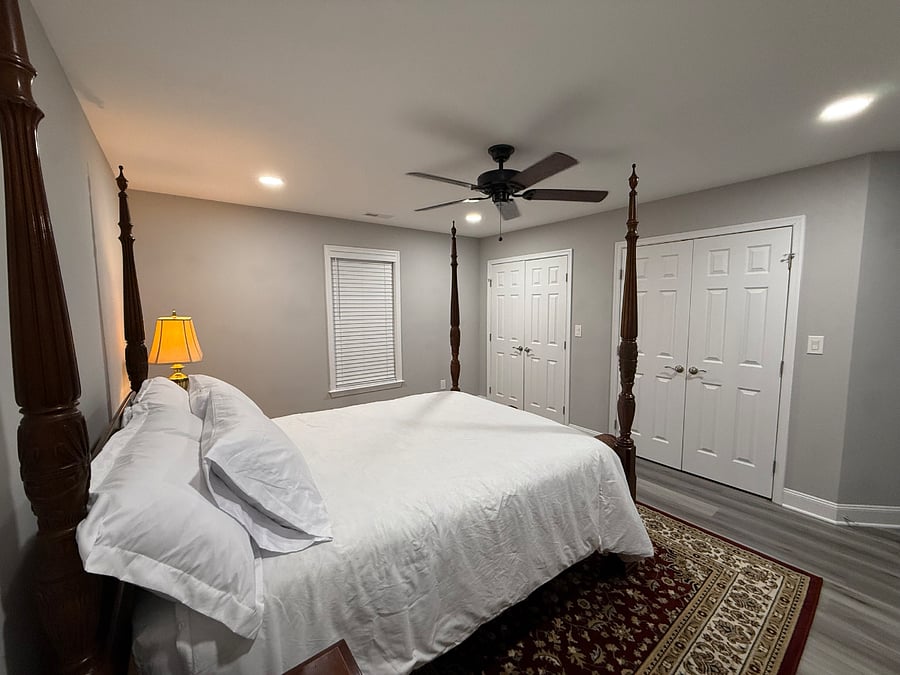 Master Bedroom; four-poster queen bed, ceiling fan, and two closets.