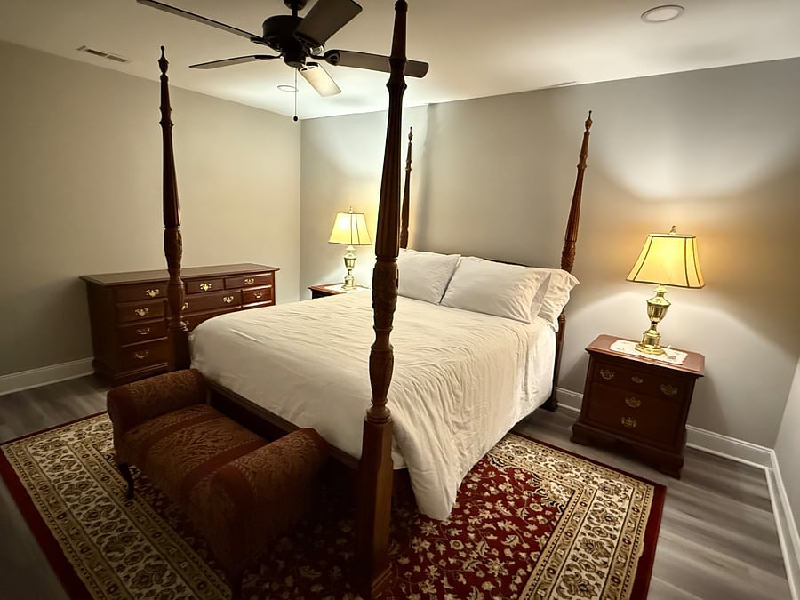 Master Bedroom. Pictured: the queen bed, ceiling fan, side tables, and chest of drawers. (Ceiling light is off)