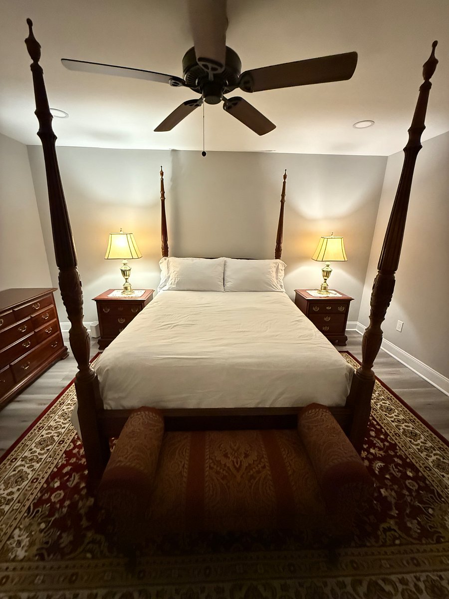 Master Bedroom. Pictured: the queen bed, ceiling fan, side tables, and chest of drawers. (Ceiling light is off)