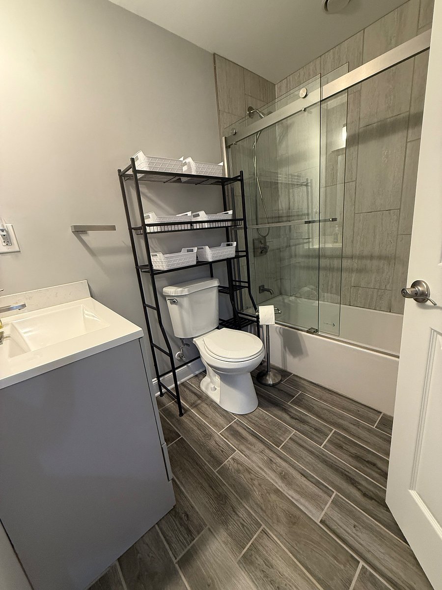 Hallway Bathroom: includes a shower, bathtub, and sink.