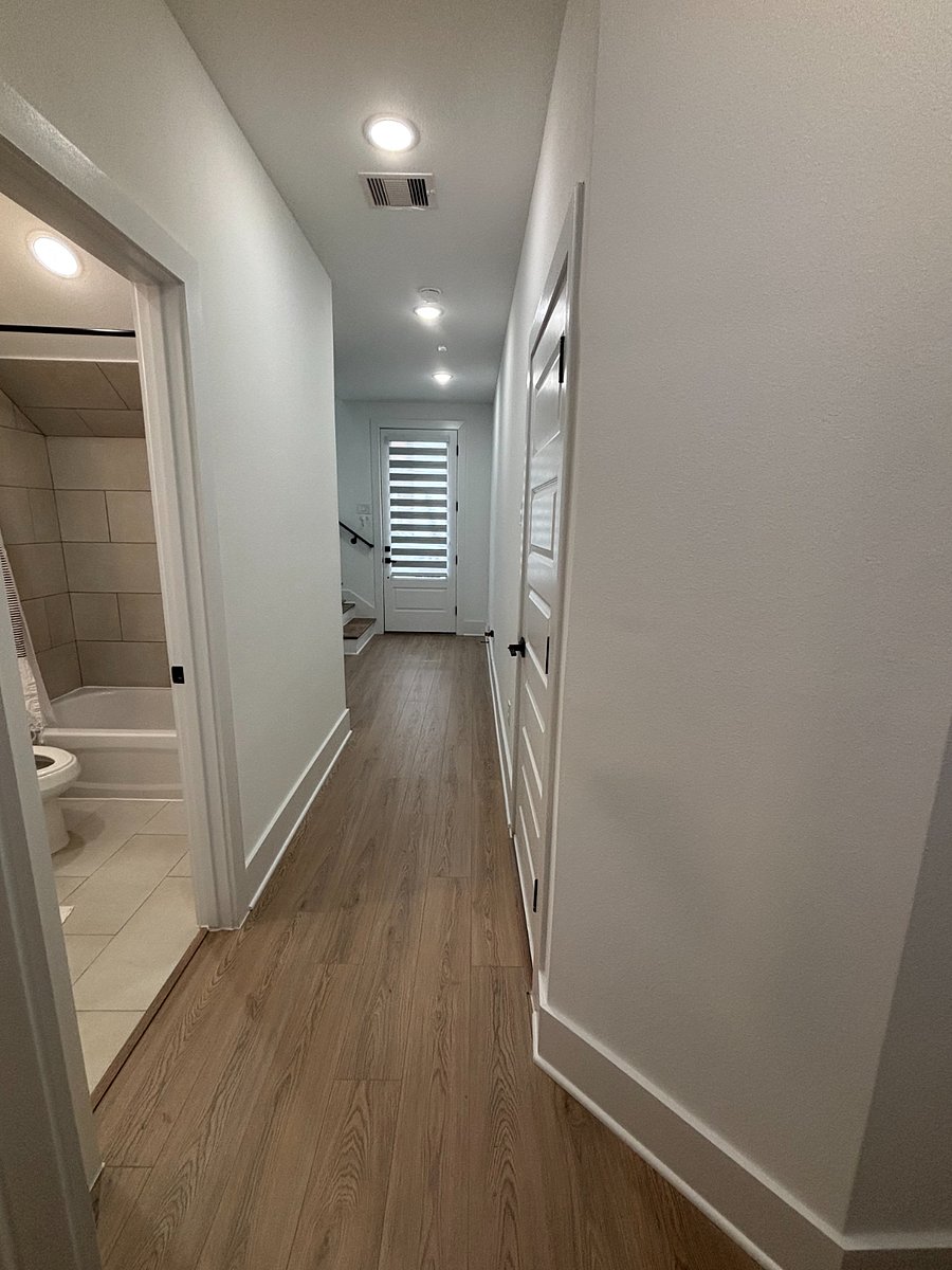 Hallway to front door, your dedicated bathroom on right, and room on left.