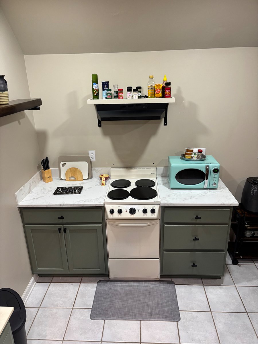 Stove and microwave with fully stocked kitchenette. Plenty of cabinet storage space