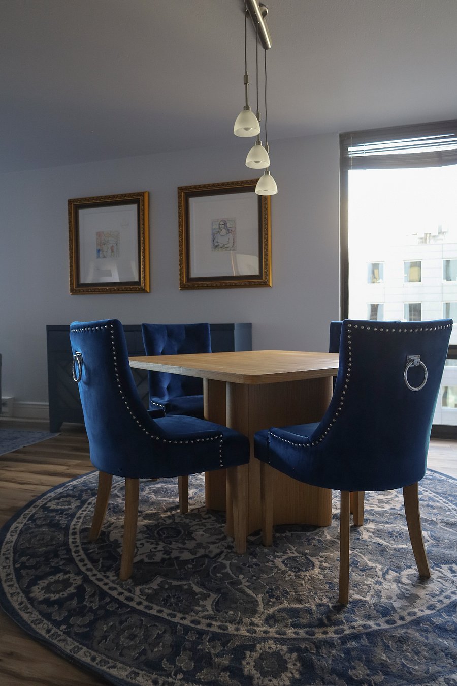 Classy Dining room with stunning artwork hanging above the hutch with wine fridge (stocked with one bottle per month of your lease).