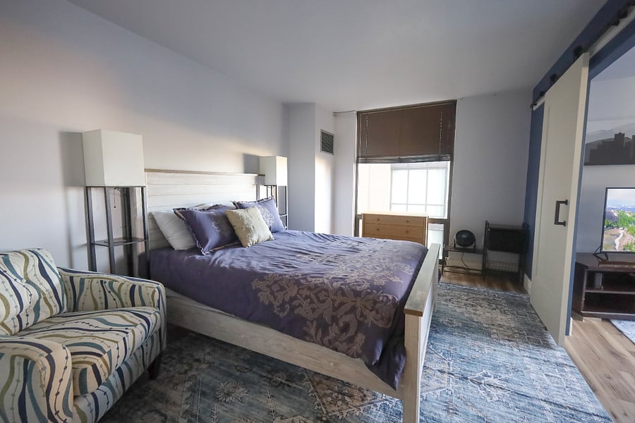 The main bedroom opens up to the living room. It is connected to the main bathroom, and has a closet and dresser.