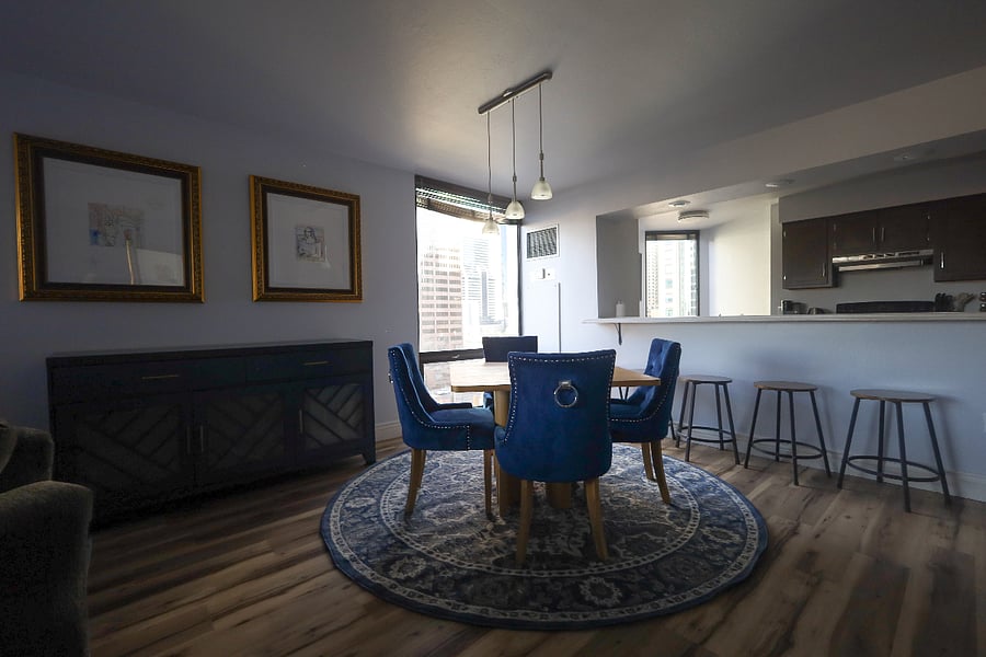 Classy Dining room with stunning artwork hanging above the hutch with wine fridge.