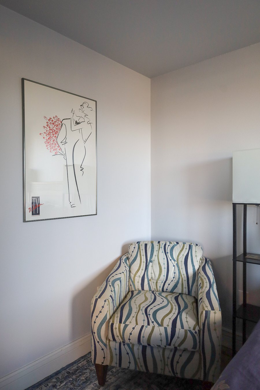 A cozy chair in the bedroom gives you a place to sit, as long as you place your clothes in the closet or dresser. 