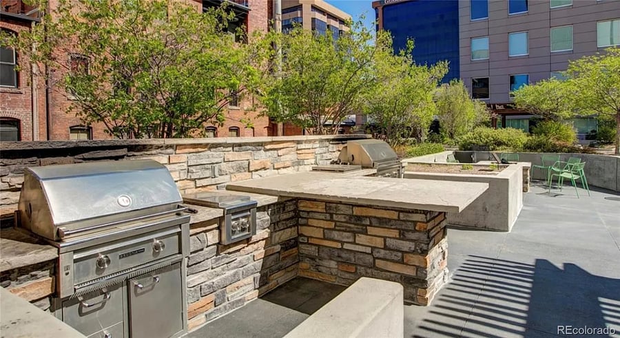 The community garden on the 4th floor roof has grill, tables and large screen TVs for resident's use.