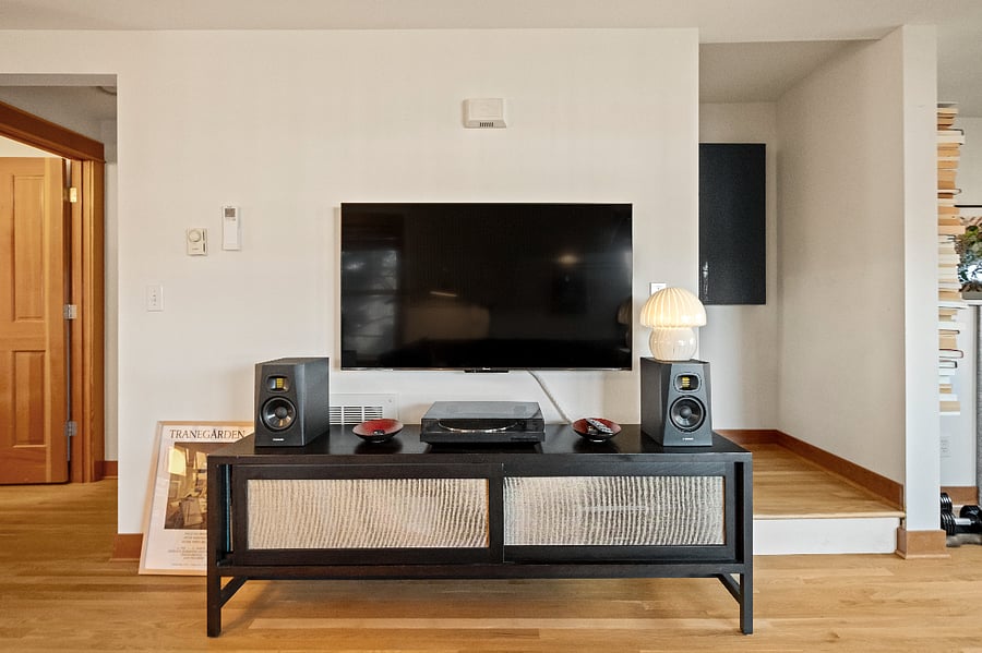 Entertainment center includes Apple TV, stereo system, and record player