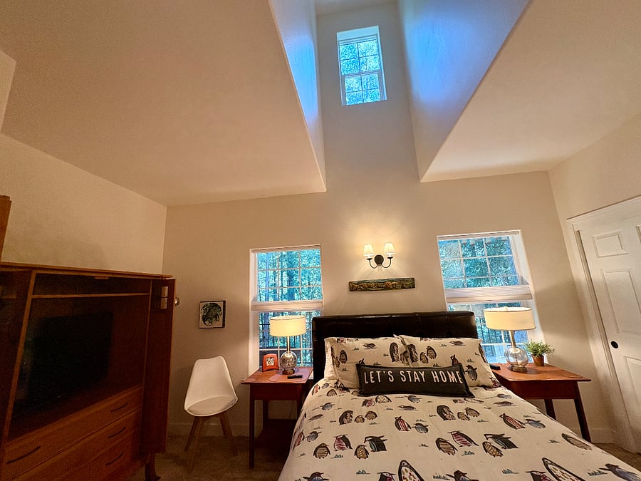 Main bedroom with dormer above bed for added light and tree views.