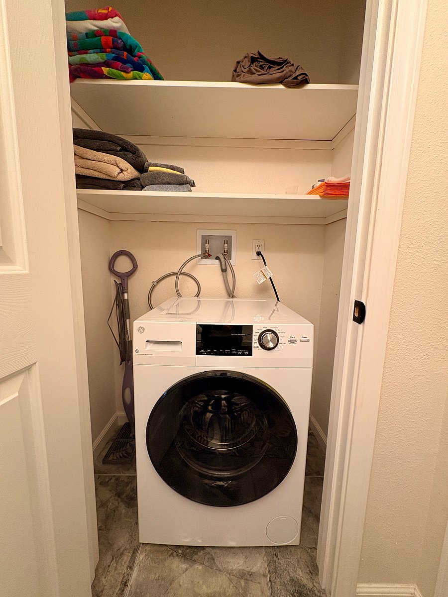 All-in-one washer/dryer in bathroom closet.