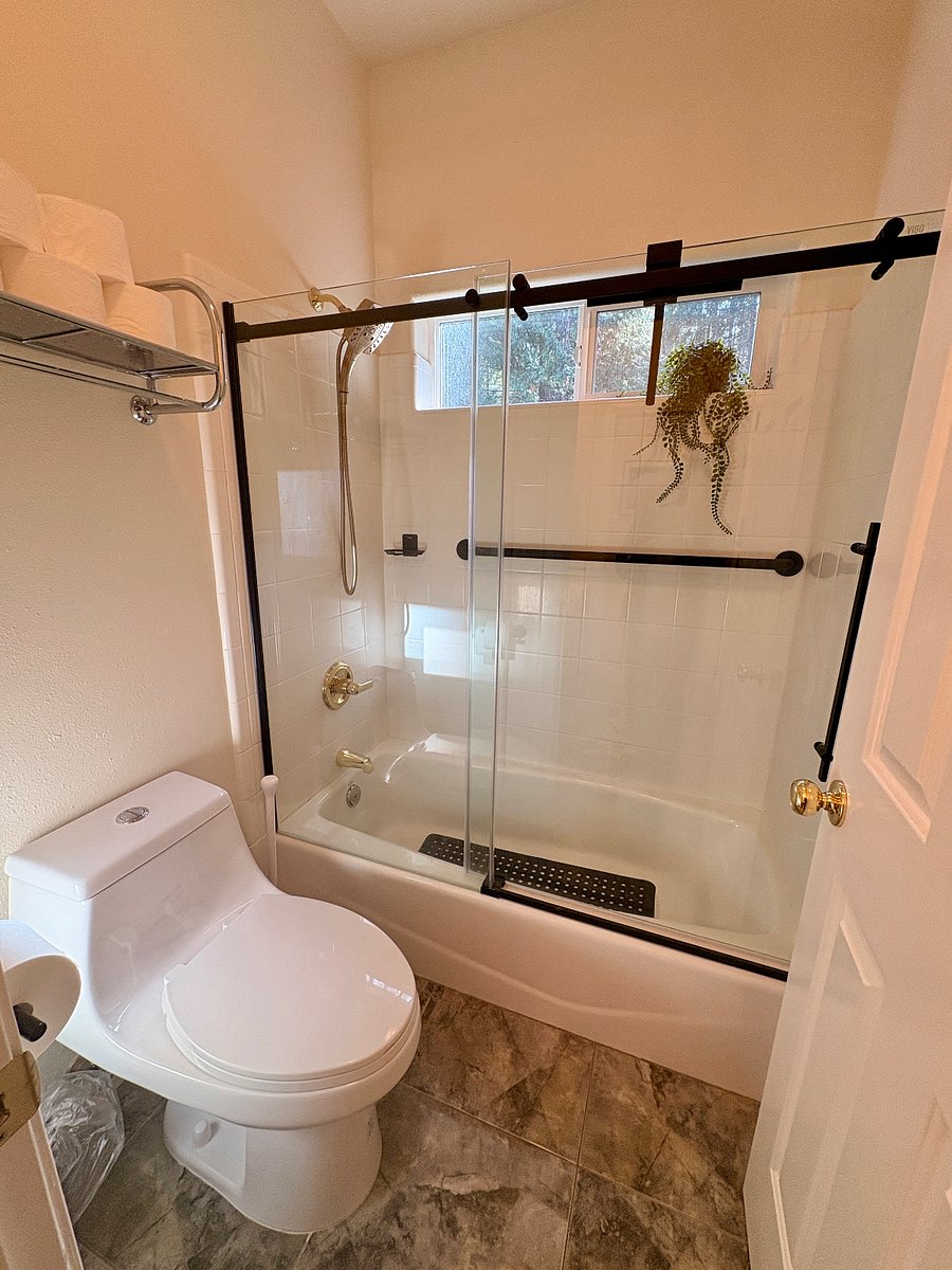 Toilet and tub/shower area separated from sink area by a door.