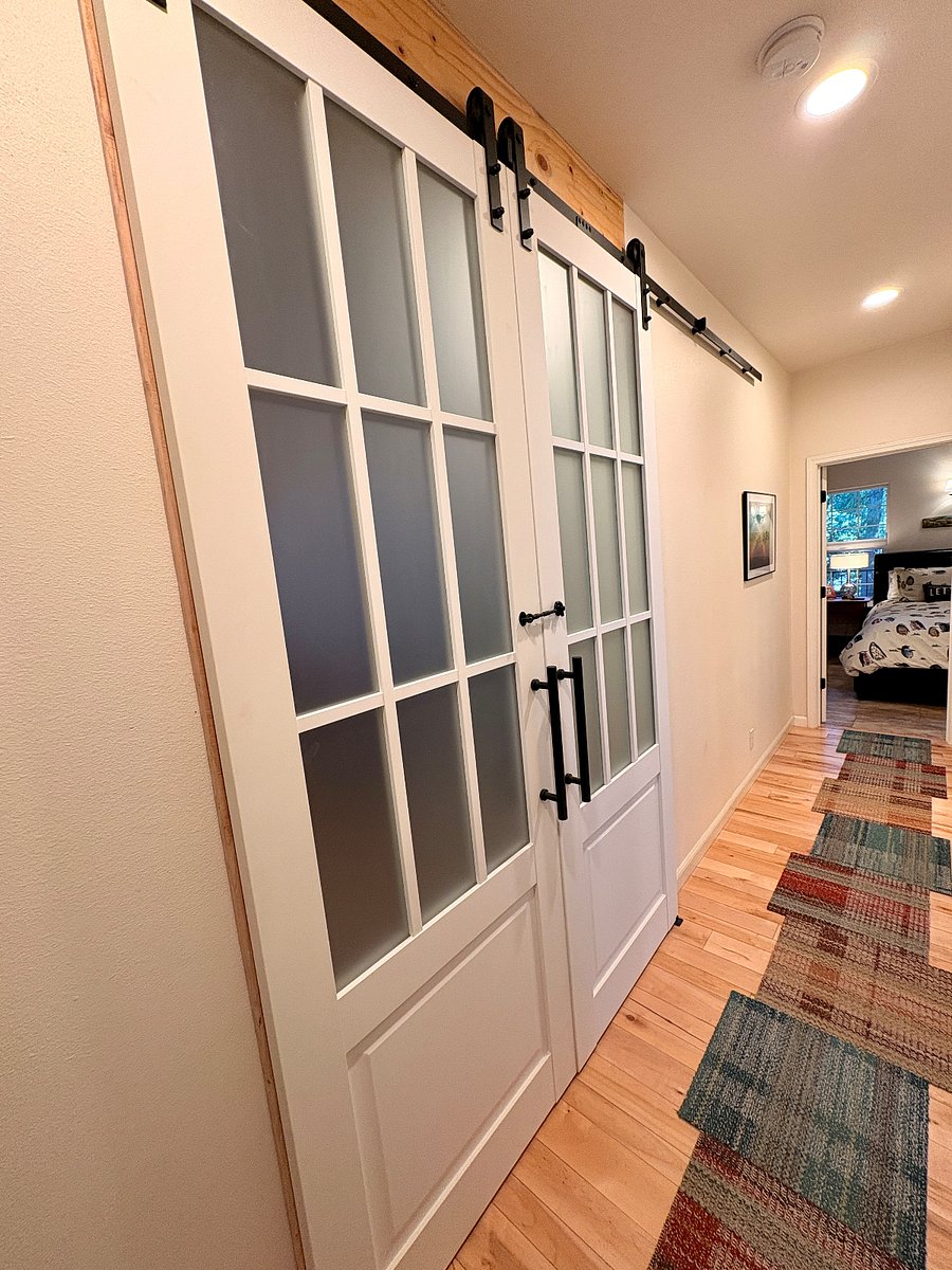 Unit is separated from main home by barn doors. There are hook latches on both sides of doors for security. Trim was added around the doors for added privacy and noise reduction.