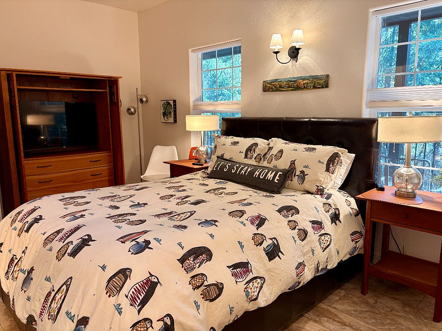 Main bedroom with queen storage bed and 43" Roku SmartTV.