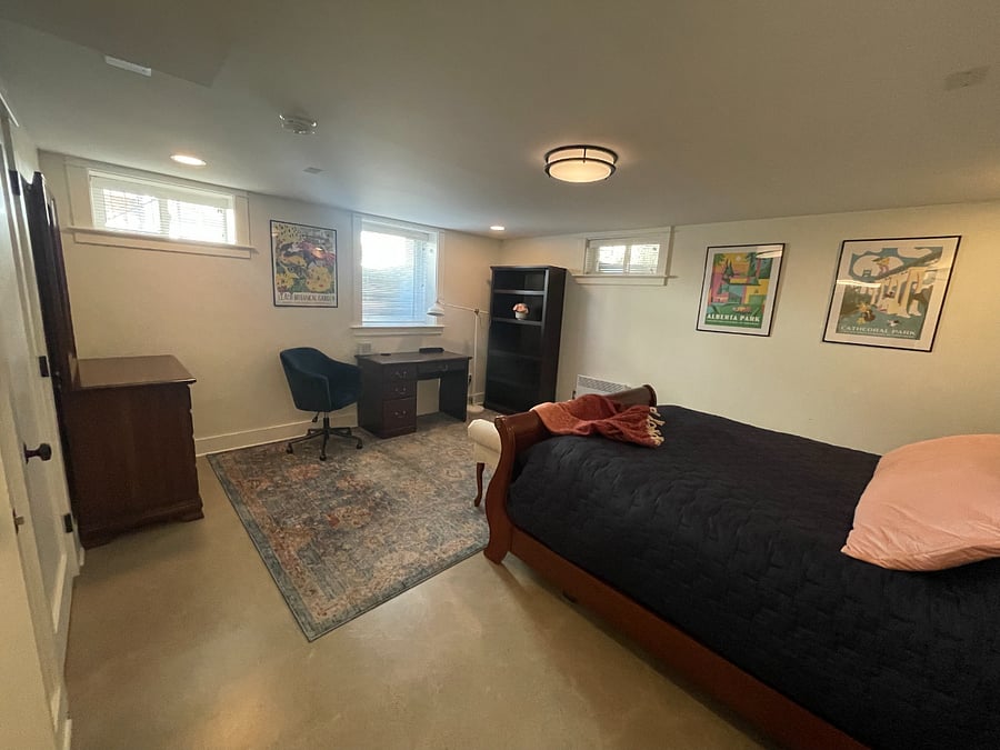 Bedroom with dedicated desk and shelves.