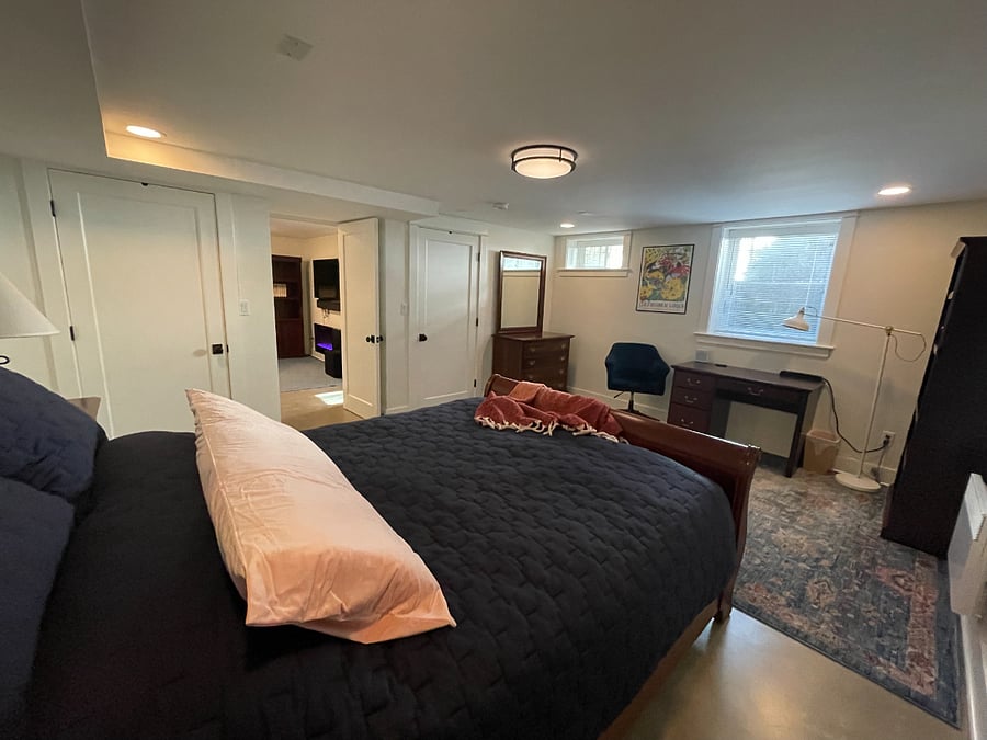 Bedroom facing living room with dresser and two closets.