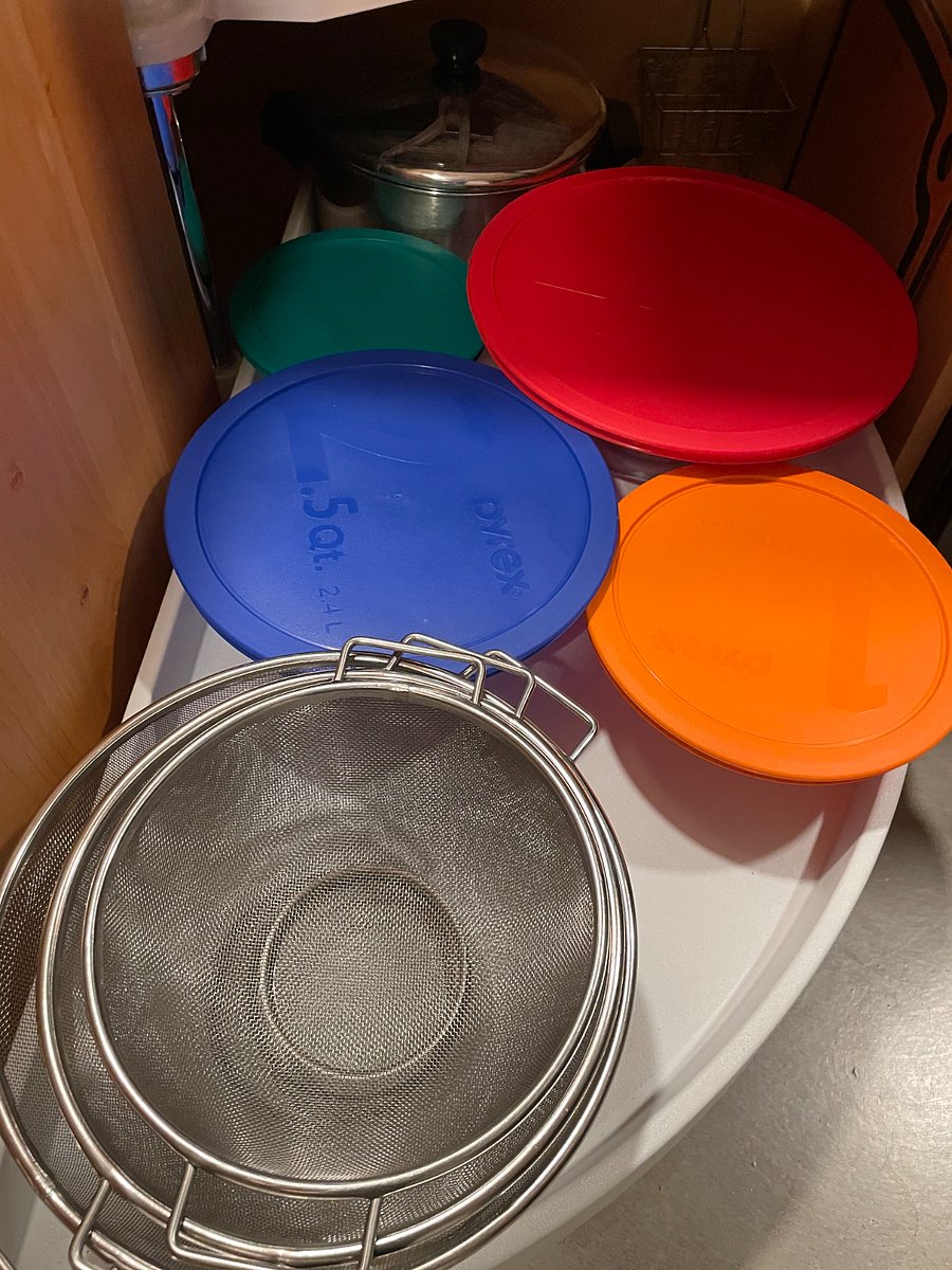 Colanders, bowls with lids and large pot.