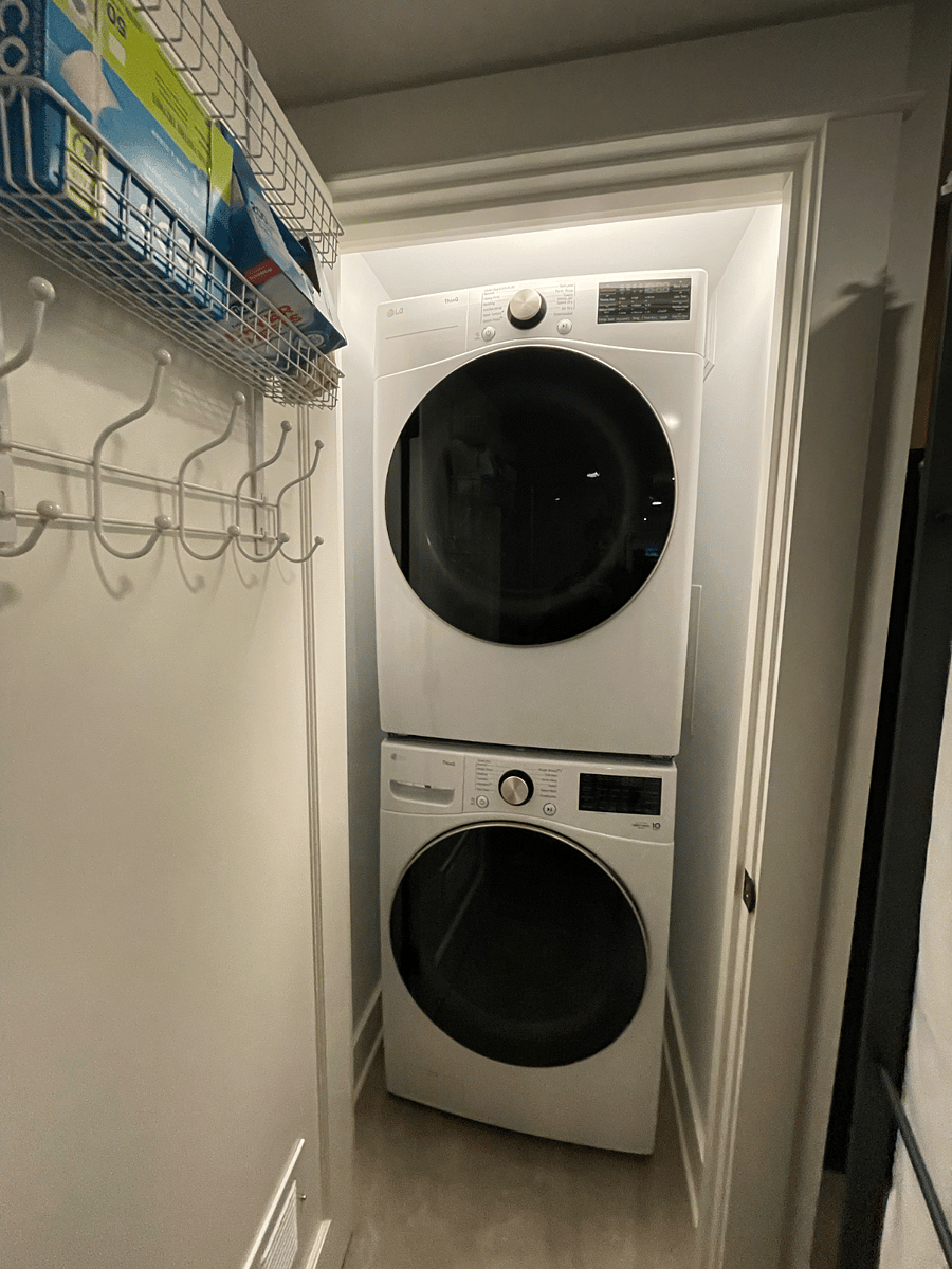 Laundry closet with full-size washer and dryer.