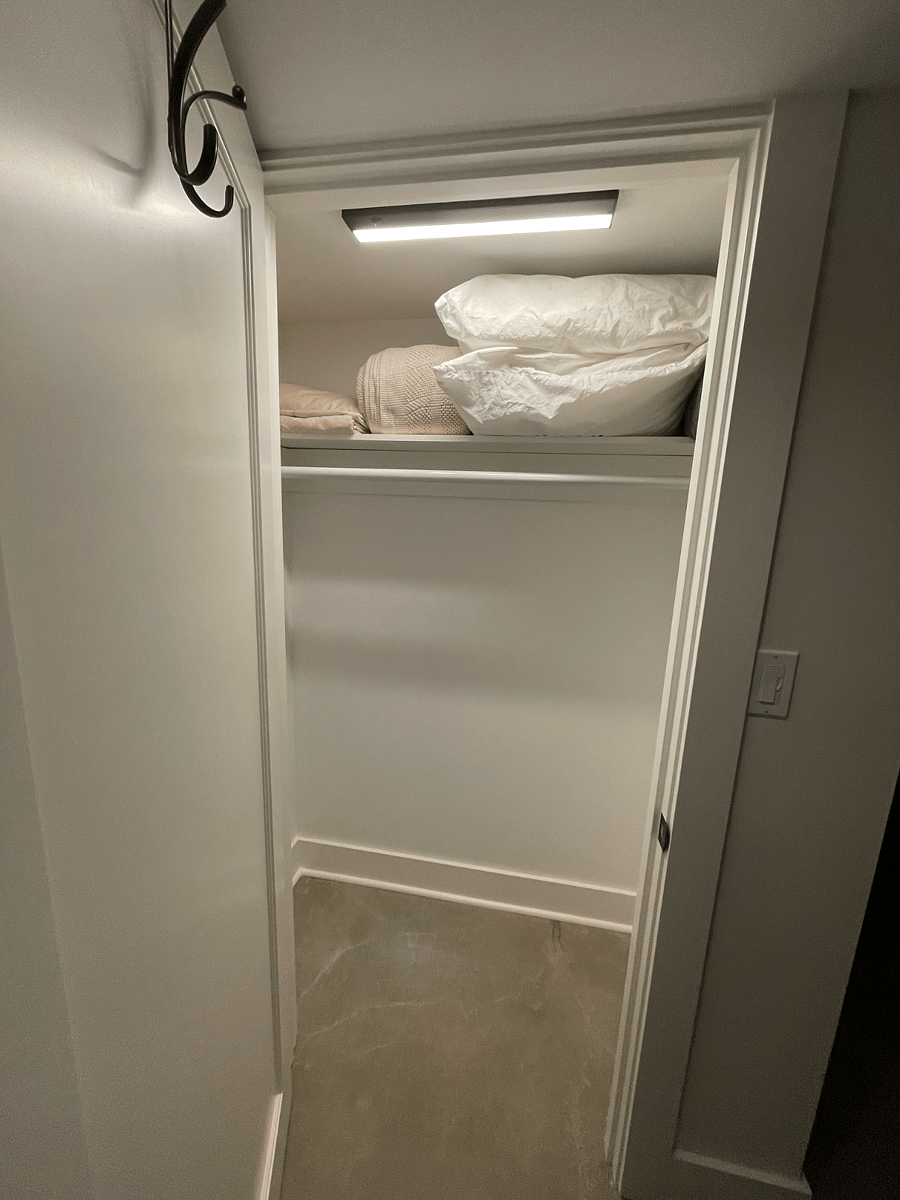Second bedroom closet with pillows, extra linens, and fire blanket.