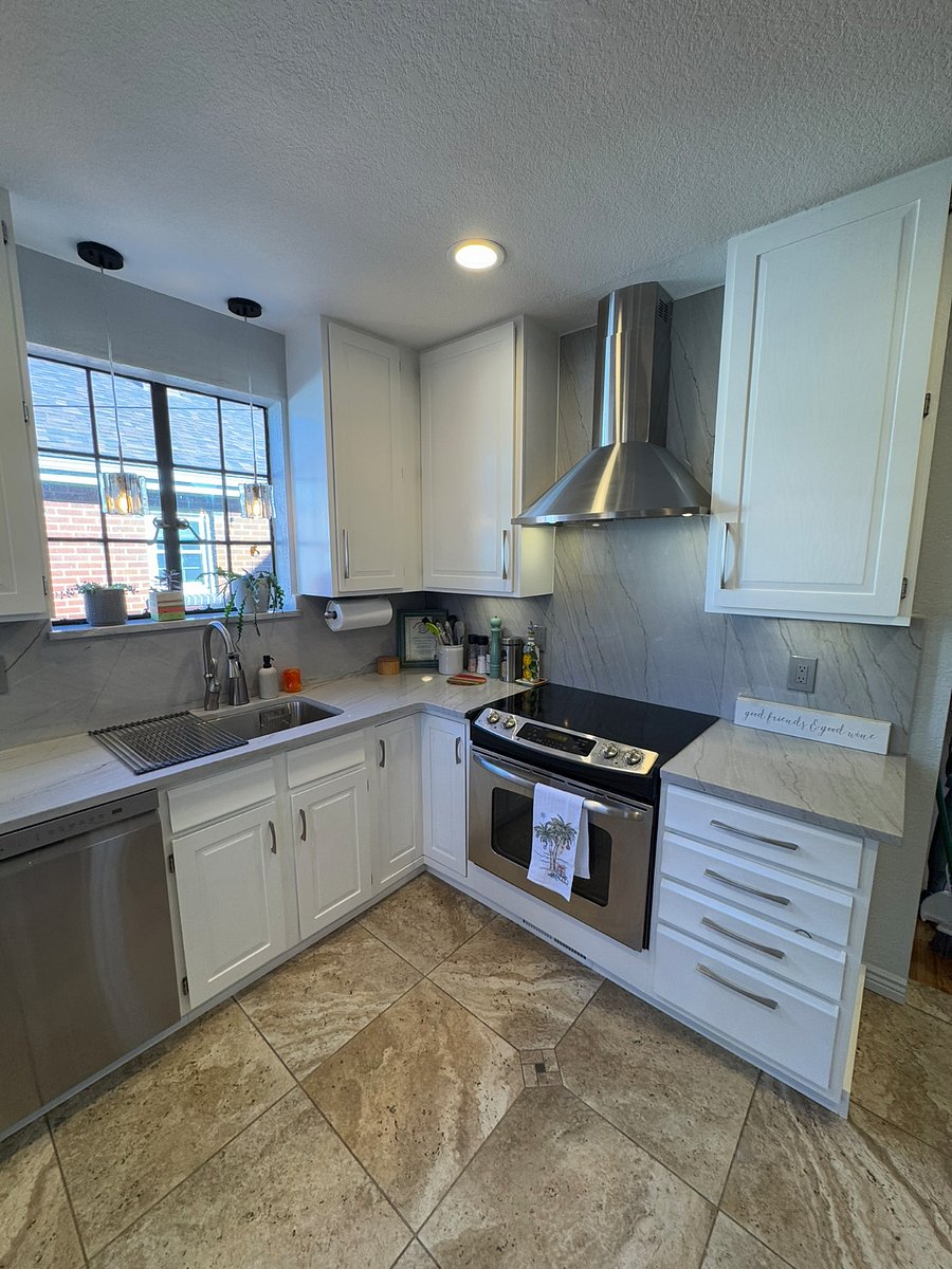 A cook's dream with light bright updated kitchen, fully stocked with all necessary cooking supplies