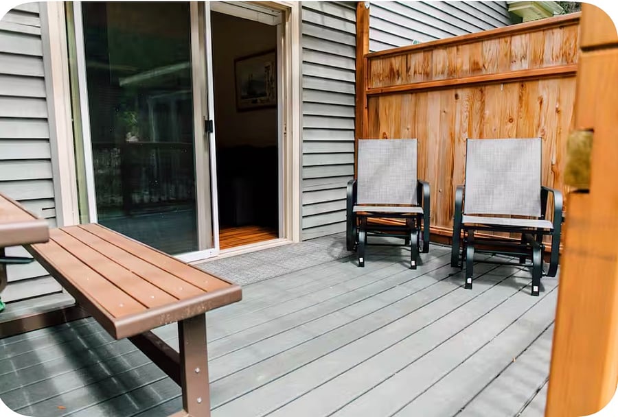Private patio contains two chairs, convertible bench and BBQ