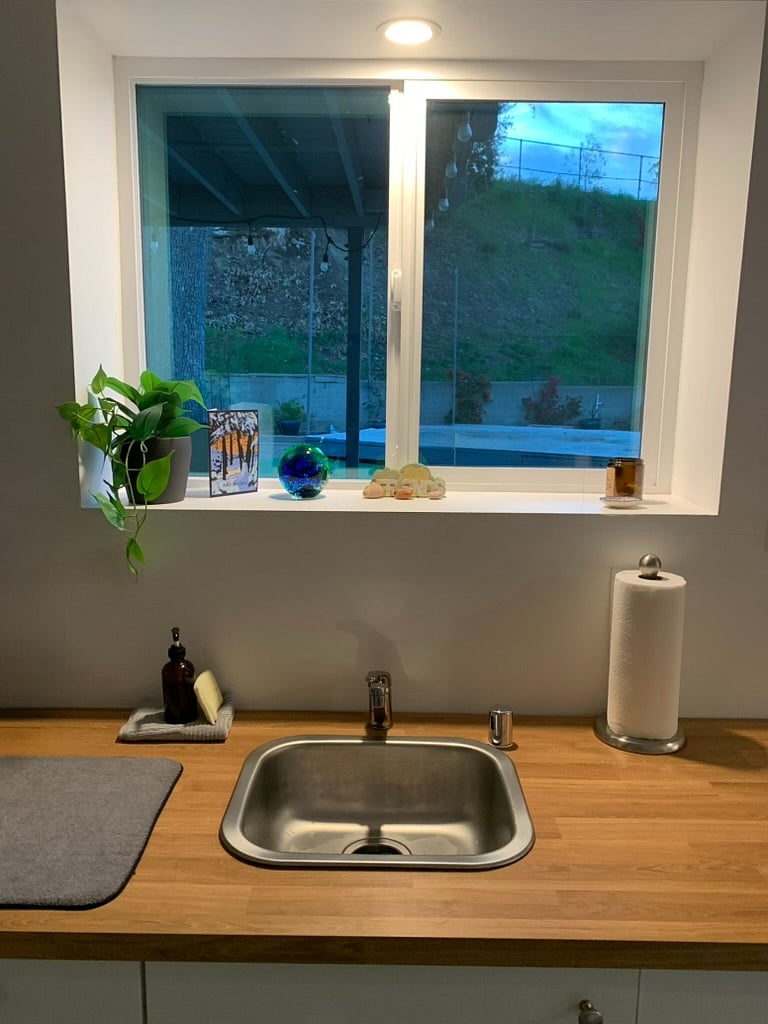 New construction sink with wood finish counter. 