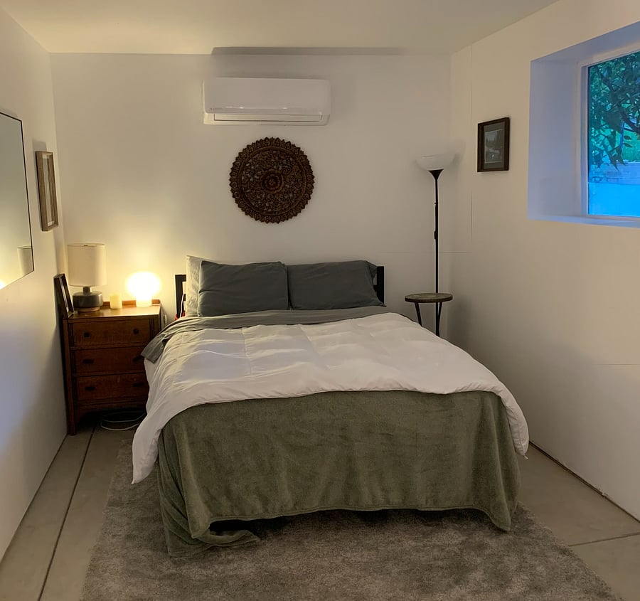 Sleeping area with queen bed designed for rest and comfort.