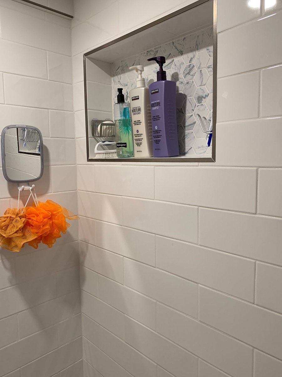 Walk-in shower and clean white tile finishes