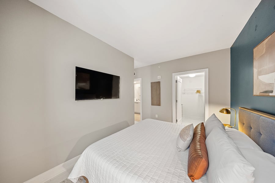 Large King bed in the bedroom with black out curtains and Smart Roku TV.