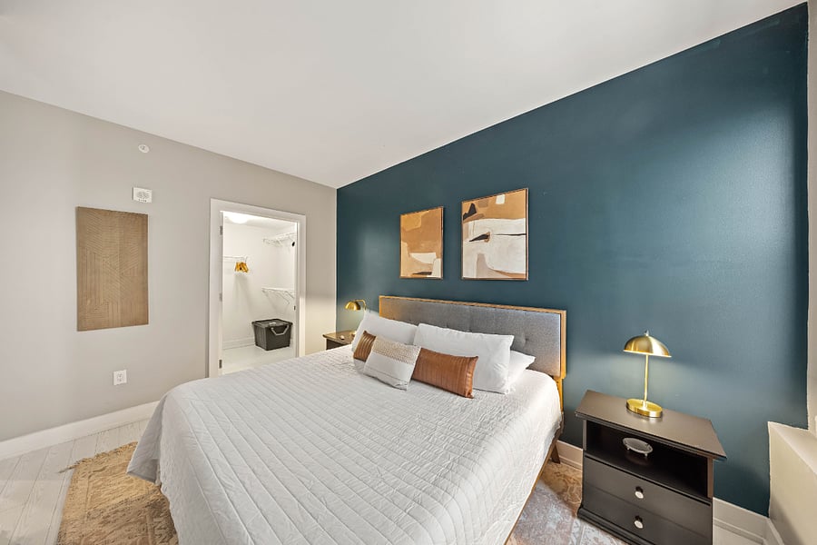 Large King bed in the bedroom with black out curtains and Smart Roku TV.