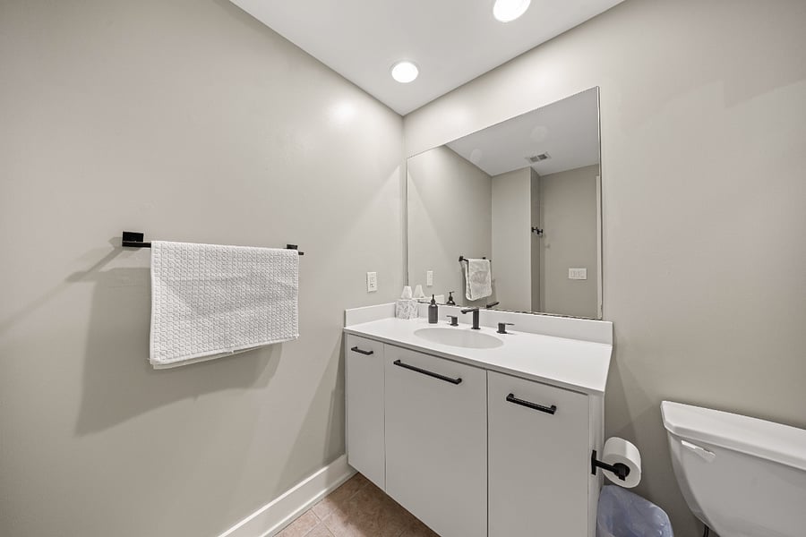 Bathroom with travel toiletries, plus soaps, room freshener, and cleaning supplies provided.