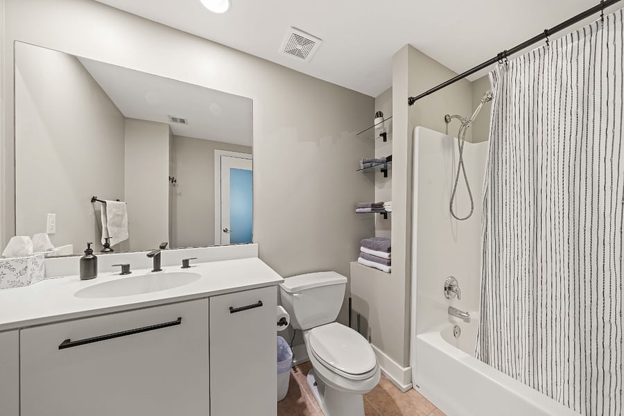 Bathroom with travel toiletries, plus soaps, room freshener, and cleaning supplies provided.