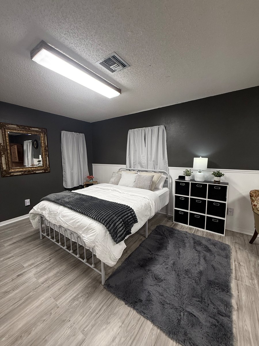 Queen-size bed with a new mattress, complete with sheets, comforter, throw blanket, and pillows, along with a nine-cube dresser for convenient storage
