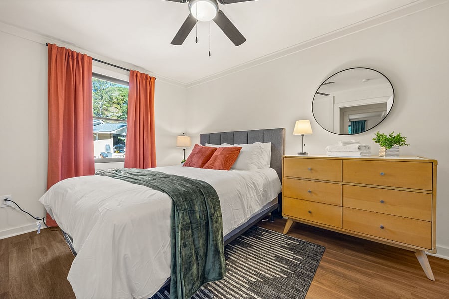 Queen size bedroom with dresser and spacious walk-in closet.