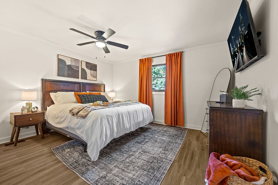 Master bedroom king size bed, dresser, Smart TV and ensuite bathroom.