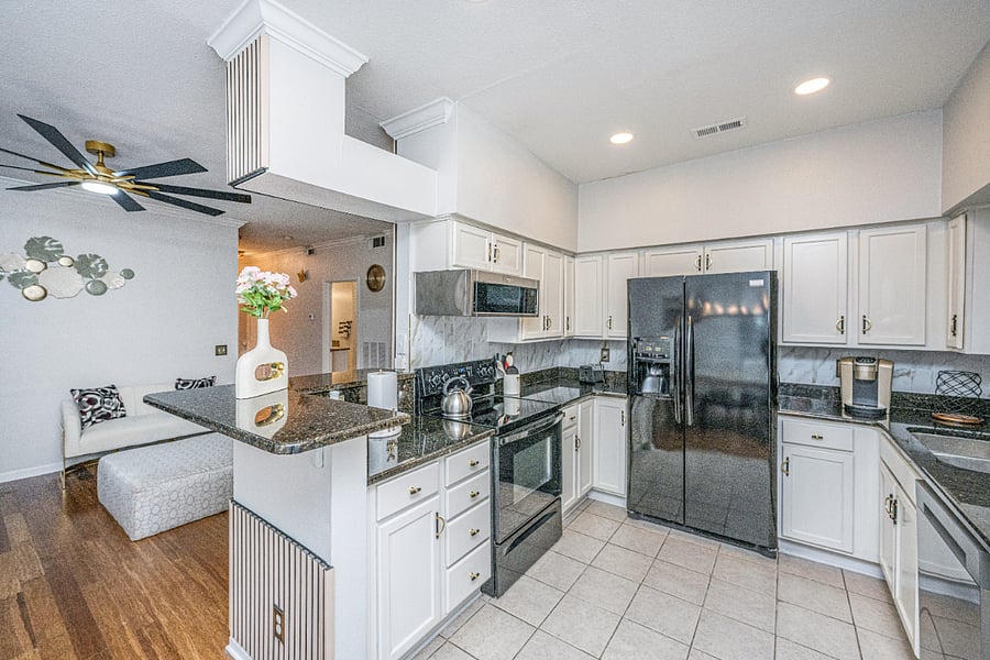 Fully equipped kitchen with cookware, dishes, and utensils